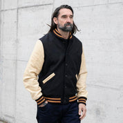 Image showing the DE-JA0002-BLK/PAL - Dehen 1920 x IH Germany Custom Varsity Jacket - Black/Palomino which is a Jackets described by the following info Dehen 1920, Jackets, Released, Tops and sold on the IRON HEART GERMANY online store