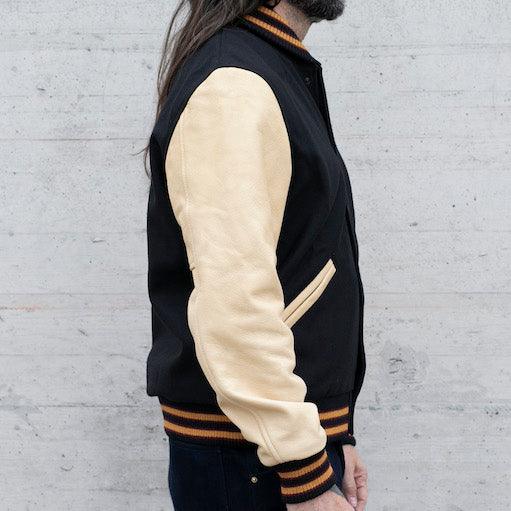 Image showing the DE-JA0002-BLK/PAL - Dehen 1920 x IH Germany Custom Varsity Jacket - Black/Palomino which is a Jackets described by the following info Dehen 1920, Jackets, Released, Tops and sold on the IRON HEART GERMANY online store