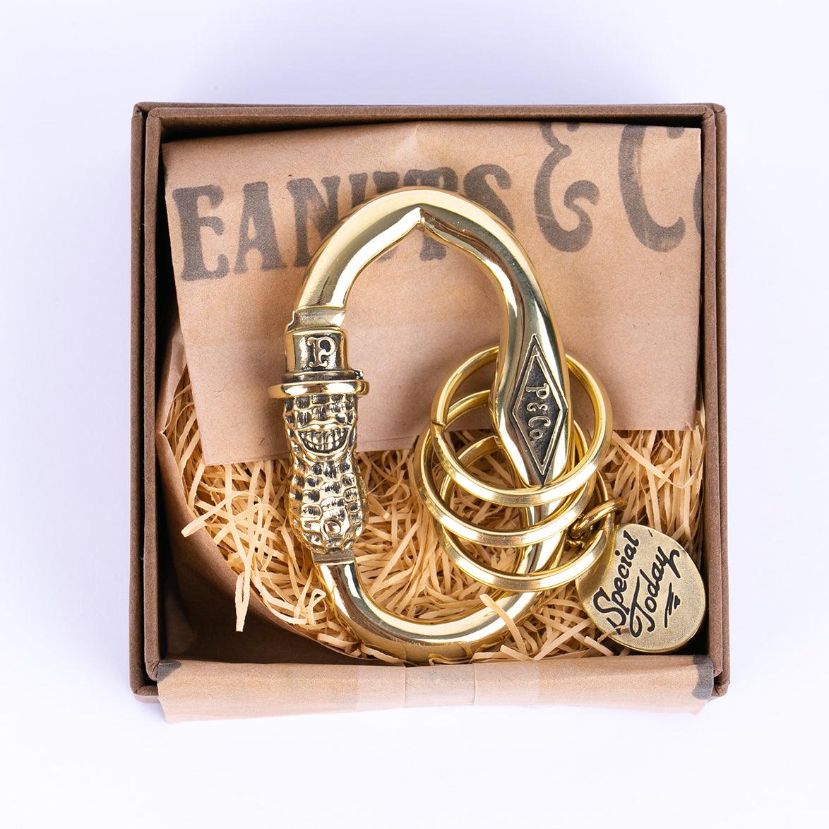 Image showing the Peanuts & Co PEANUTS CARABINER- Brass which is a Others described by the following info Accessories, Others, Peanuts & Co, Released and sold on the IRON HEART GERMANY online store