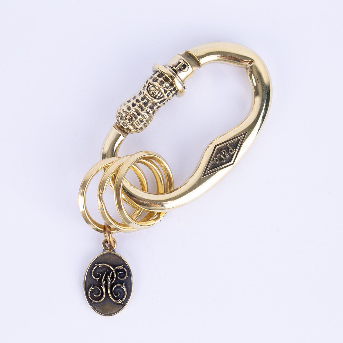 Image showing the Peanuts & Co PEANUTS CARABINER- Brass which is a Others described by the following info Accessories, Others, Peanuts & Co, Released and sold on the IRON HEART GERMANY online store