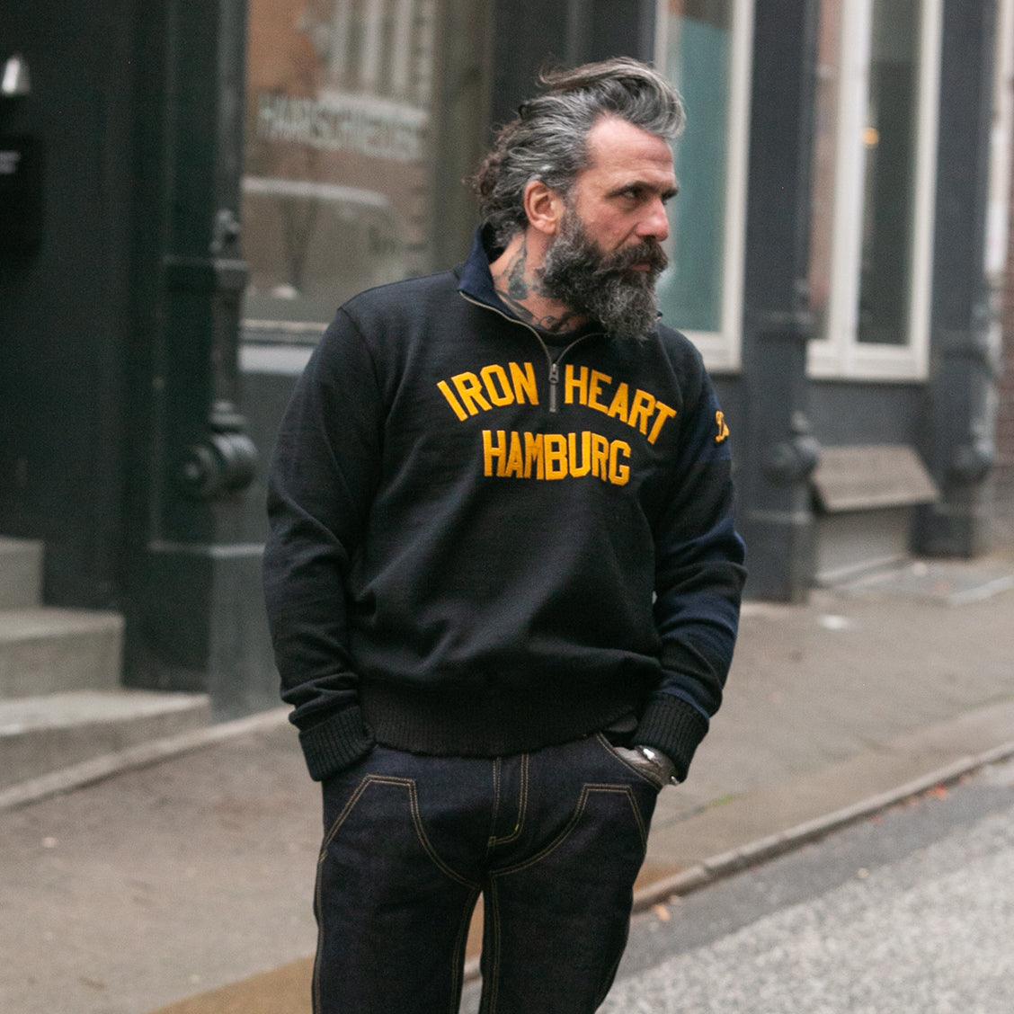 Image showing the DE-IHH-Custom-BLK - 1/4 Zip Moto-Jersey Hamburg - Black/ D.Navy which is a Knitwear described by the following info Dehen 1920, IHSALE_M23, Knitwear, Released, Tops and sold on the IRON HEART GERMANY online store