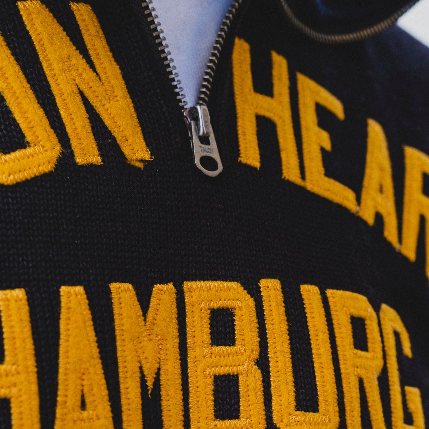 Image showing the DE-IHH-Custom-BLK - 1/4 Zip Moto-Jersey Hamburg - Black/ D.Navy which is a Knitwear described by the following info Dehen 1920, IHSALE_M23, Knitwear, Released, Tops and sold on the IRON HEART GERMANY online store